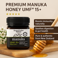 Manuka honey jar with honeycomb and flowers on a wooden board, featuring UMF certification.